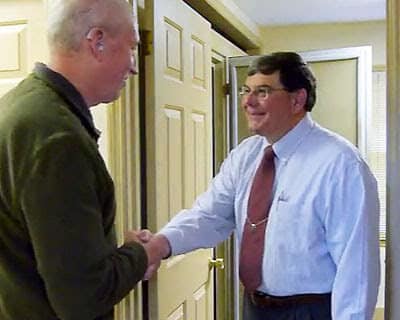 Charles Taylor welcoming a patient to the office