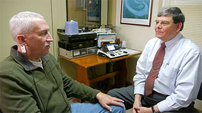 Charles Taylor consulting with a patient